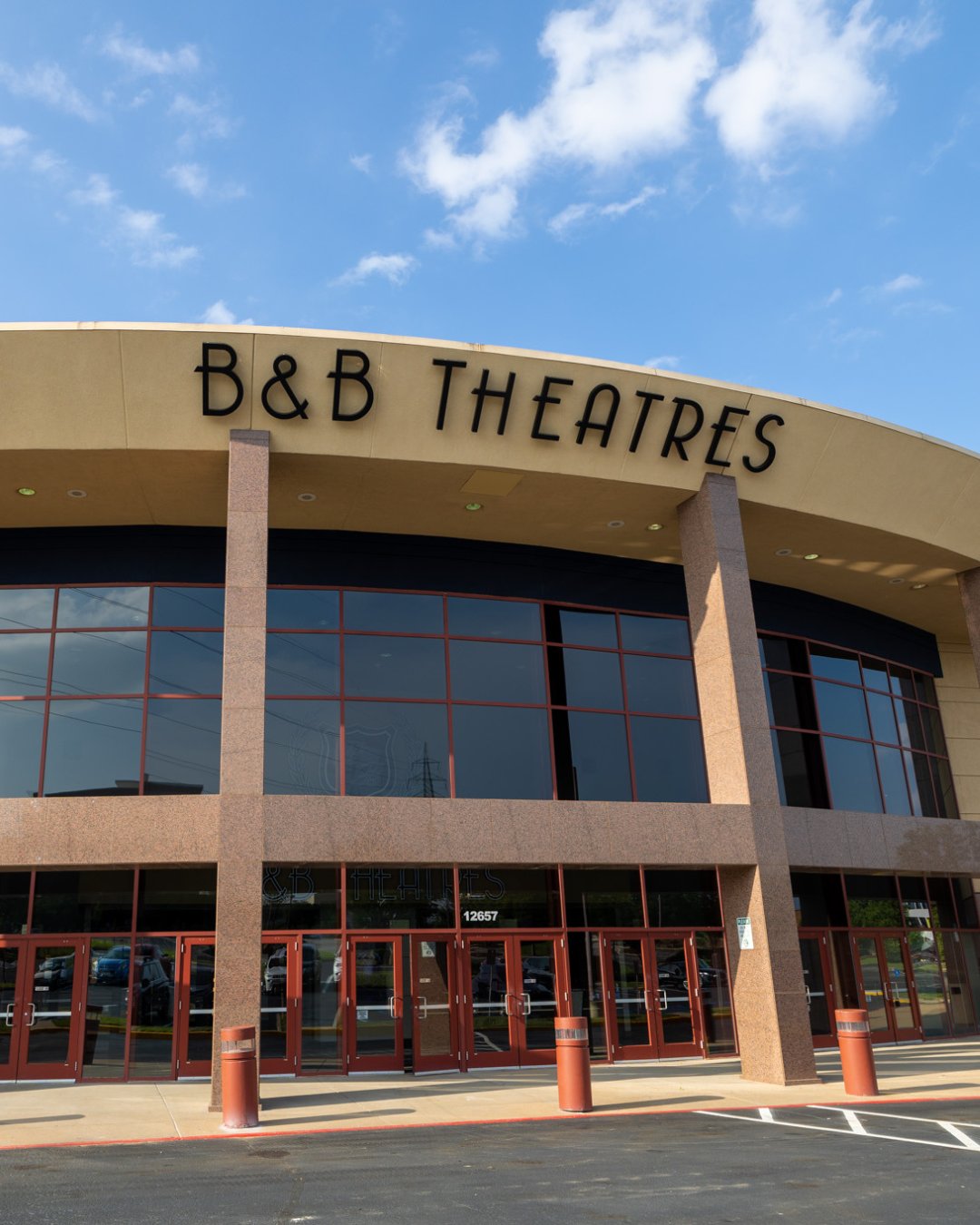 Exterior of the building. IT's a curved entrance. Across the top of the building reads "B&B Theatres"