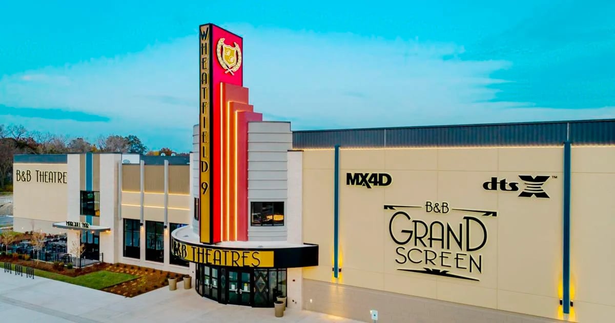 exterior of building showing different signs that read B&B THEATRES, GRAND SCREEN, MX4D, DTSX