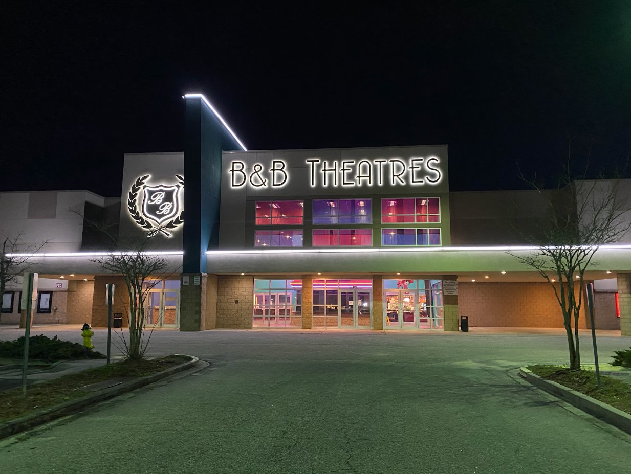 exterior of theatre building at night showing B&B Theaters sign lit up