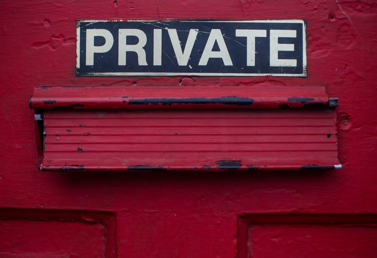 the word private on a sticker on a red door
