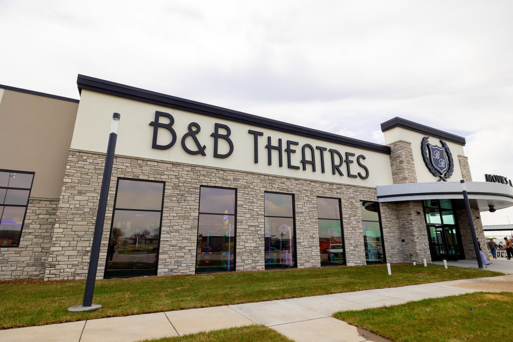 exterior image of grand island side of the building featuring a large sign that reads B&B THEATRES