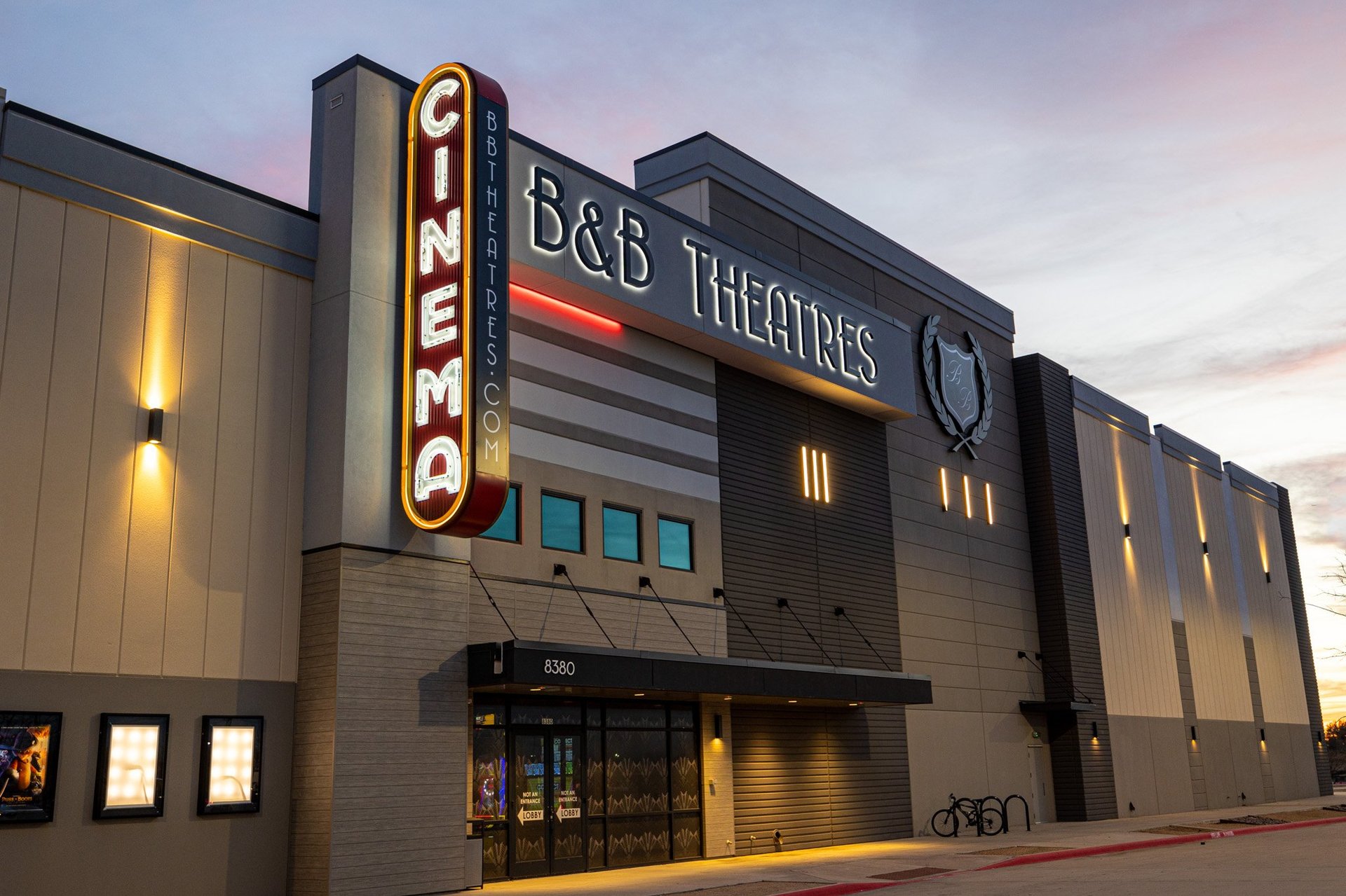 b&b theatres signage on the exterior of a cinema building lit up in the evening