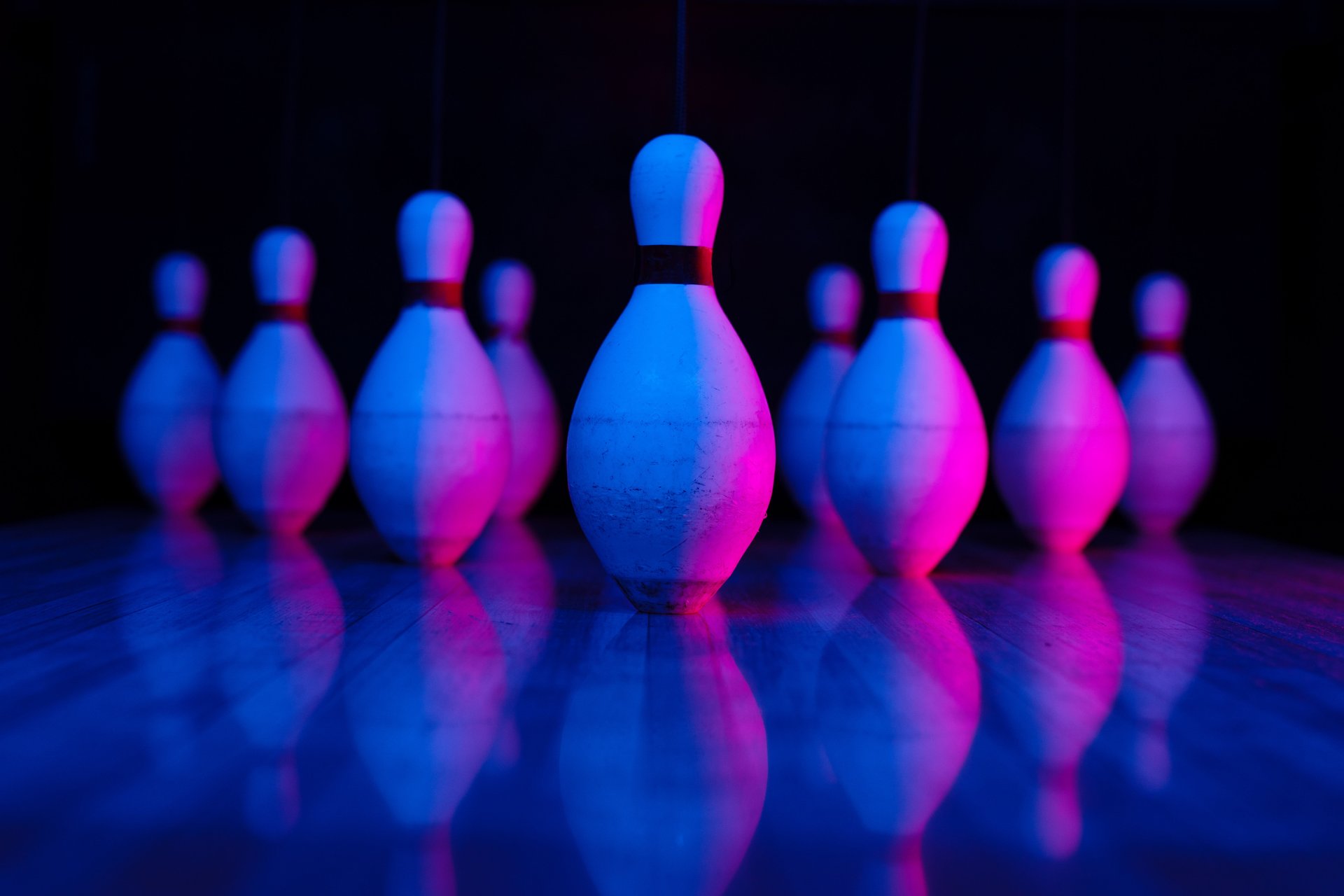 close up of pins with blue-ish pink lighting highlighting the pins