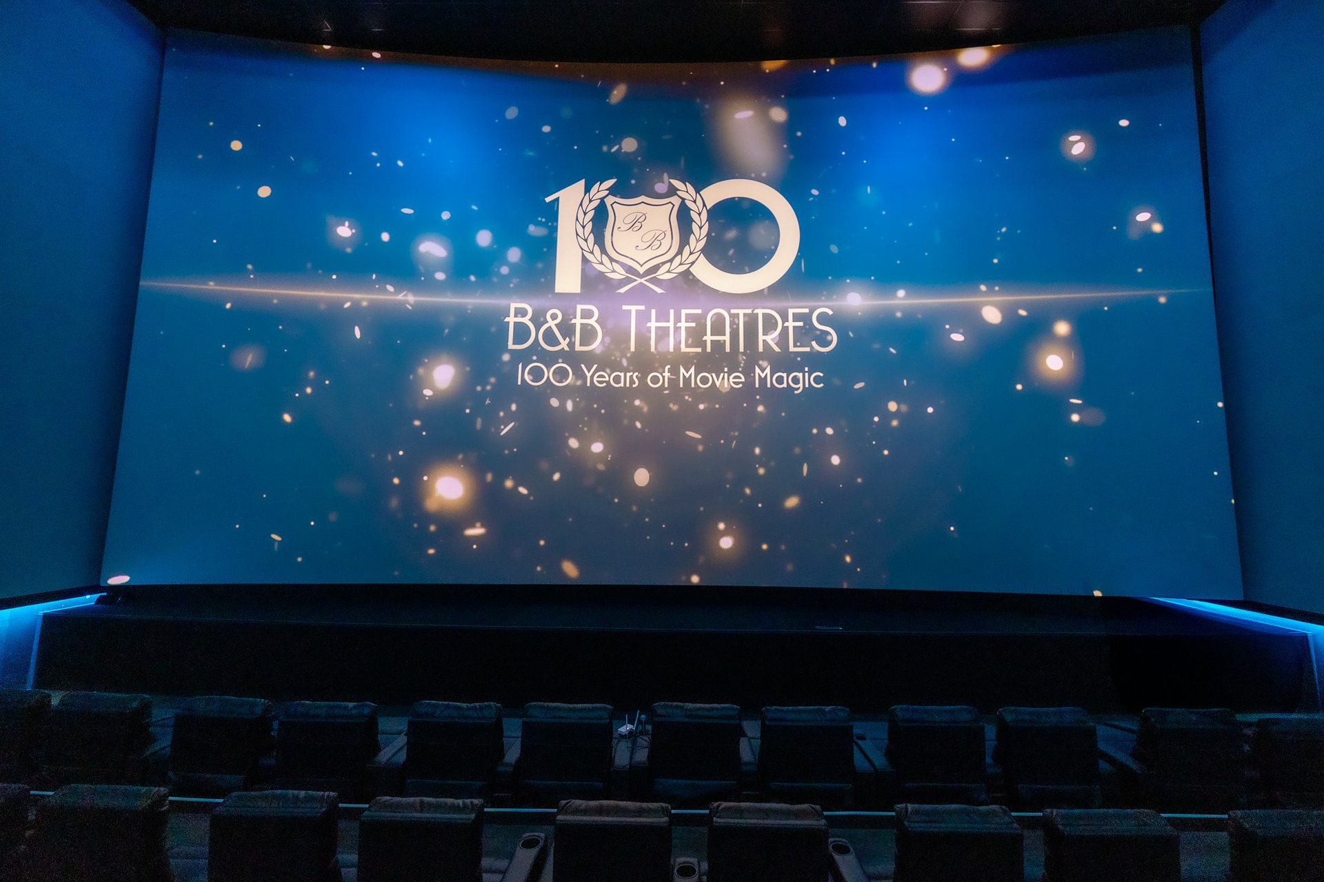 image of giant screen with sparkly B&B Theatres 100 Years of Movie Magic logo