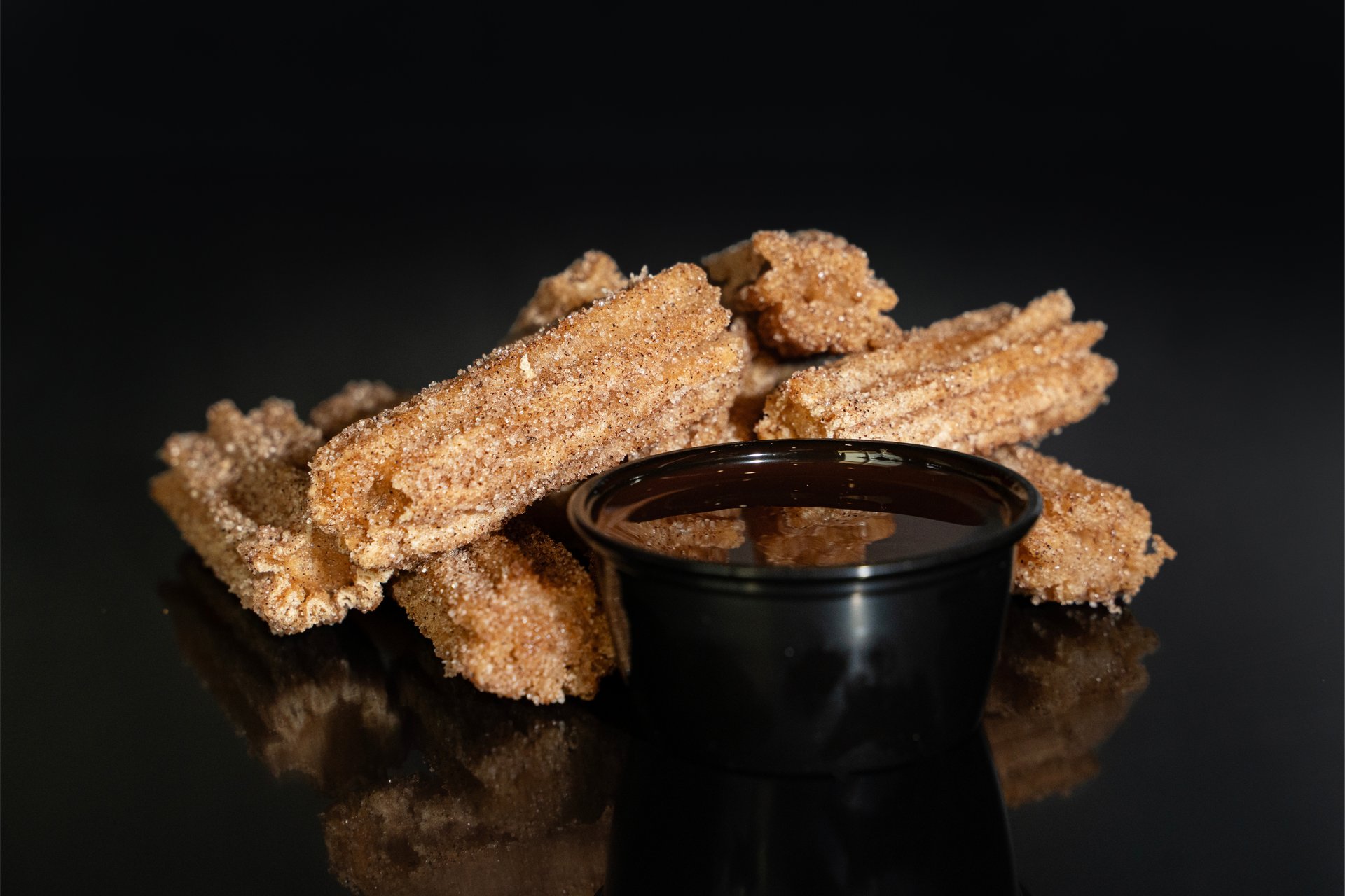 Churro bites chocolate sauce from the Marquee Bar at B&B Theatres Macedonia 15