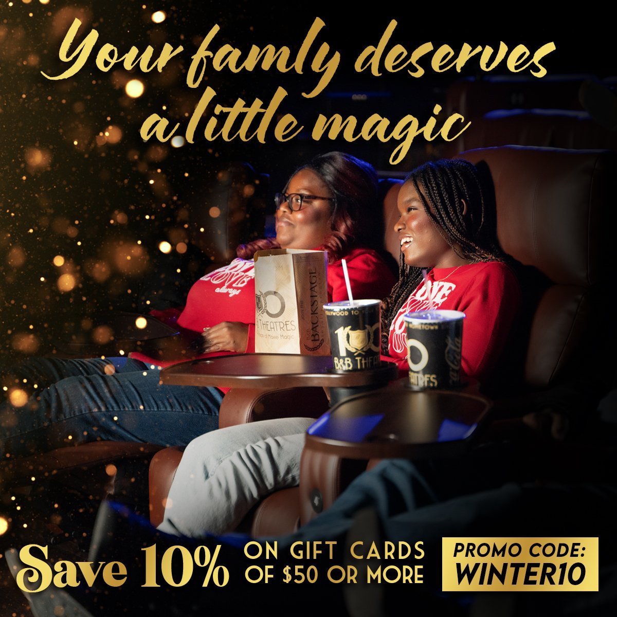 2 guests sitting in recliners smiling towards a screen (out of frame) 