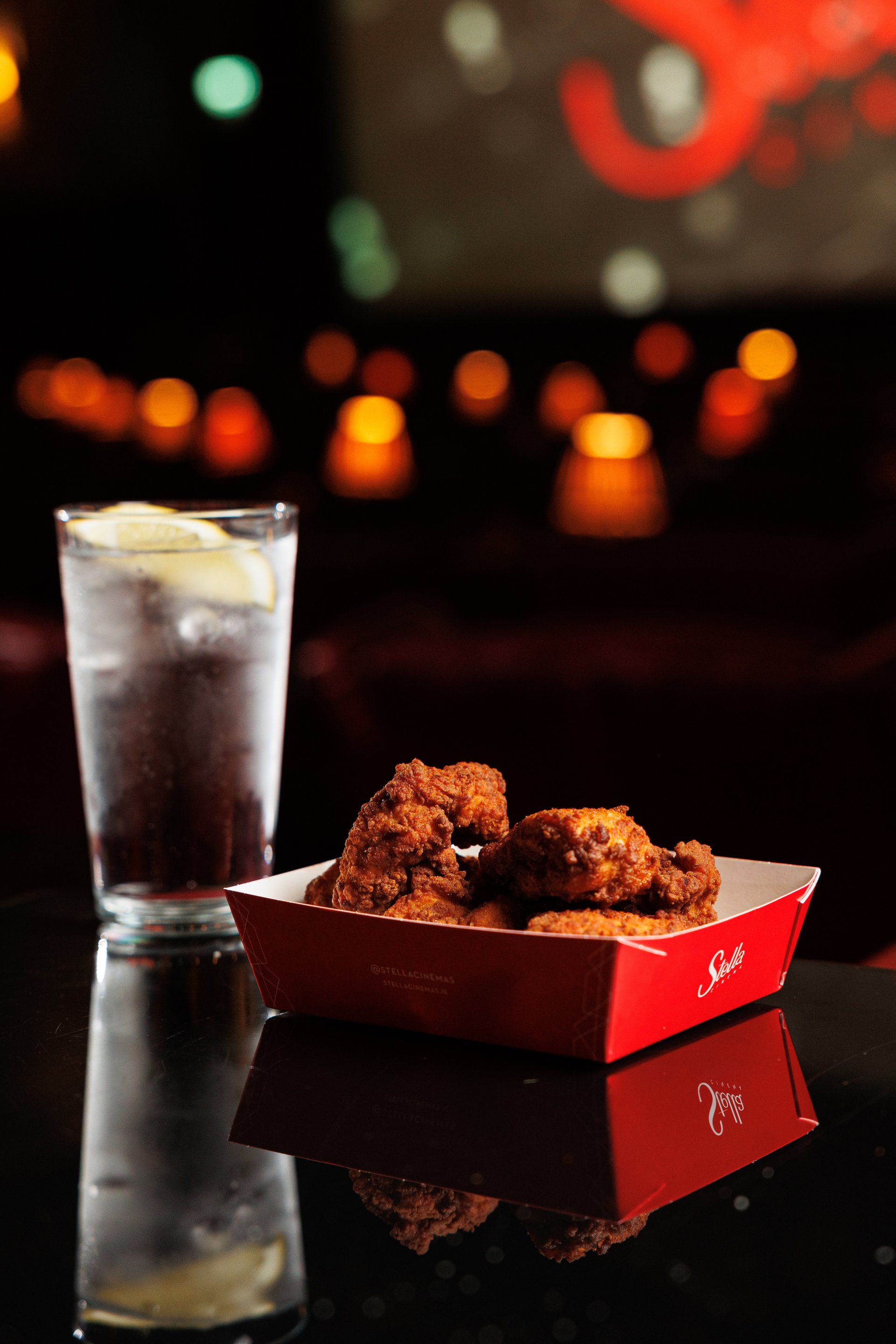 Chicken Tenders and Sprite on a table in a cinema