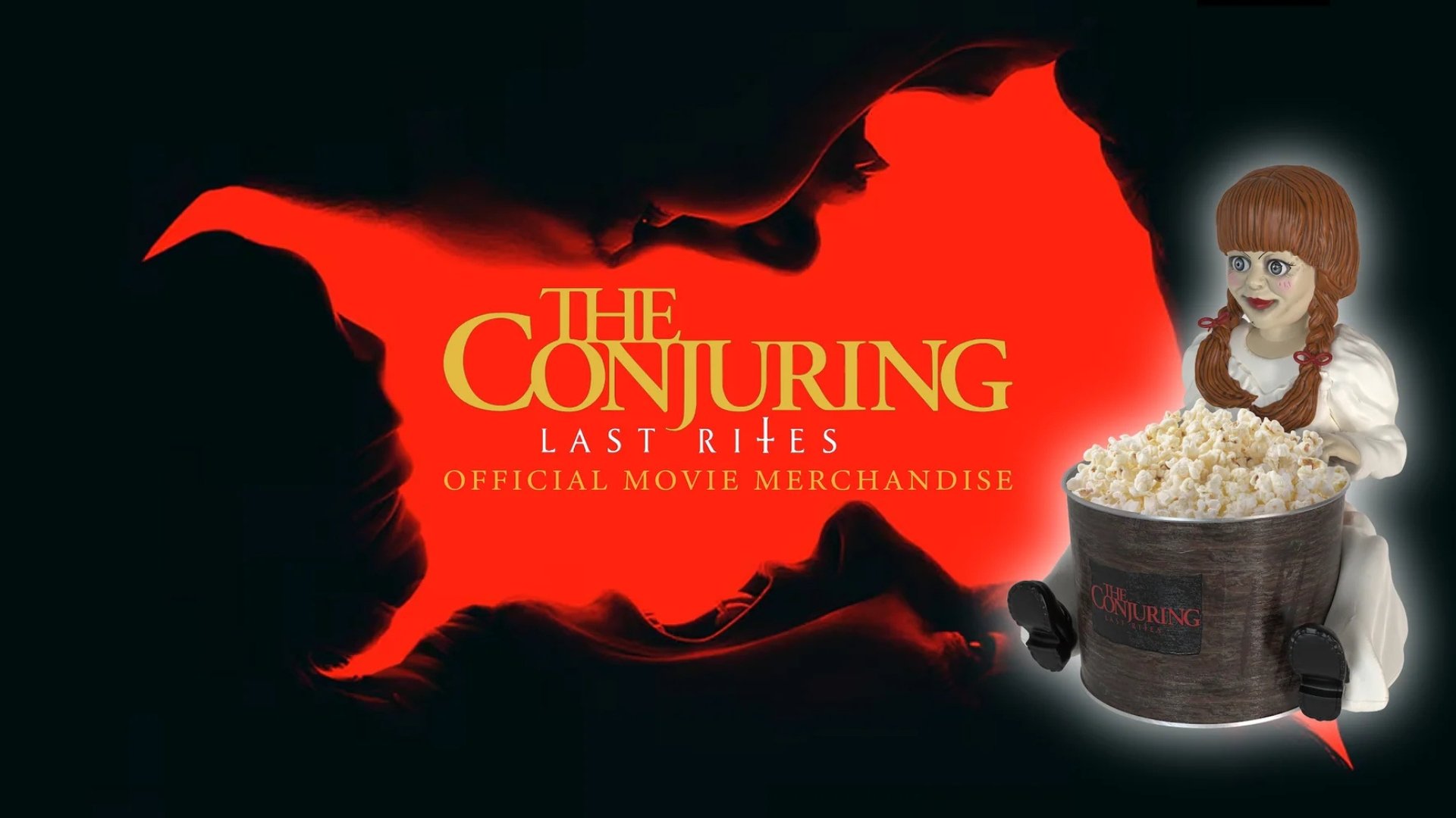 black background with red in the center. text reads The Conjuring Last Rites Official Movie Merchandise. On the far right is an image of an annabelle doll holding a bucket full of popcorn.