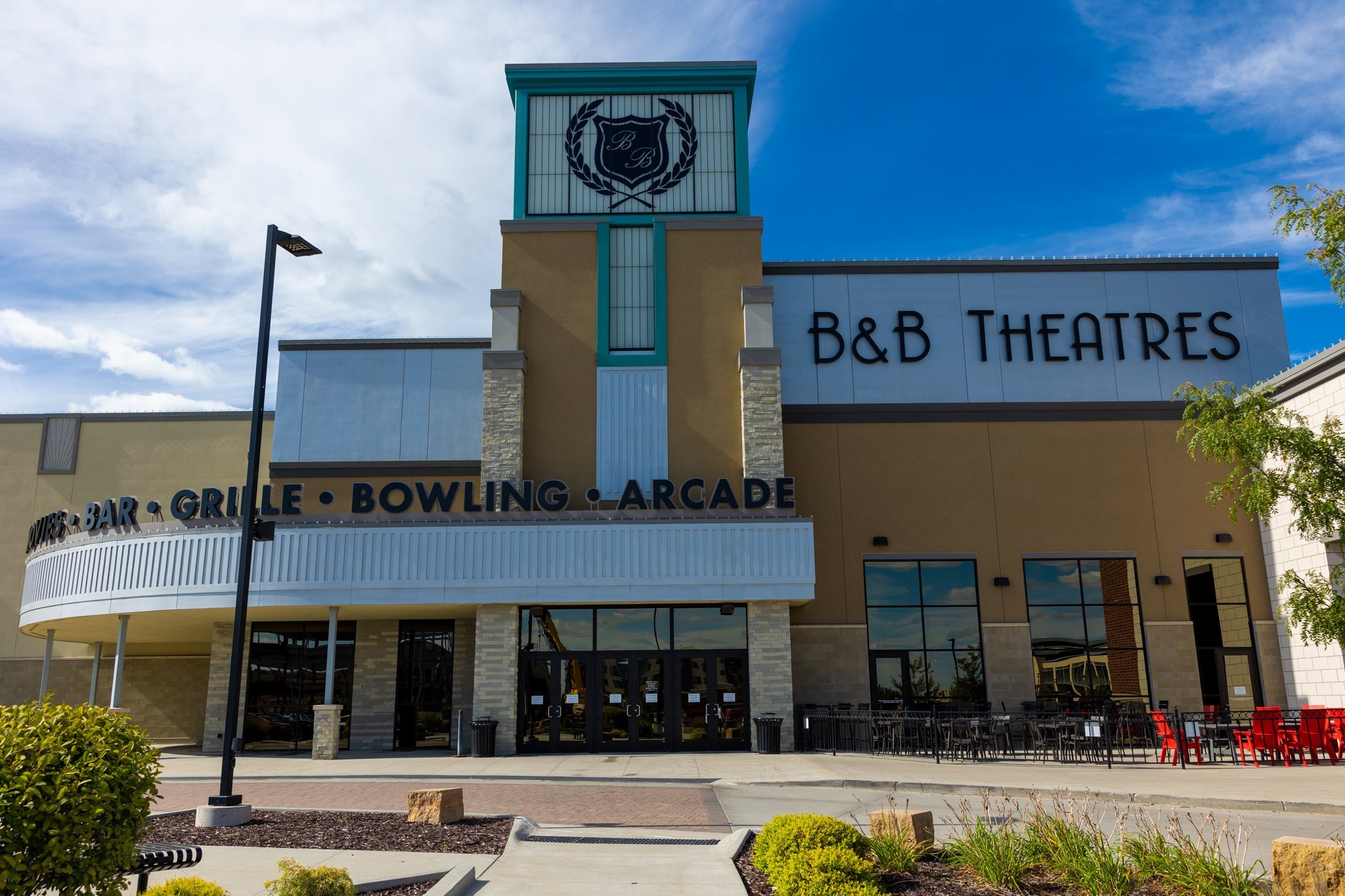 exterior photo of ankeny building. signage includes giant black logo, B&B THEATRES, BAR, GRILLE, BOWLING, ARCADE