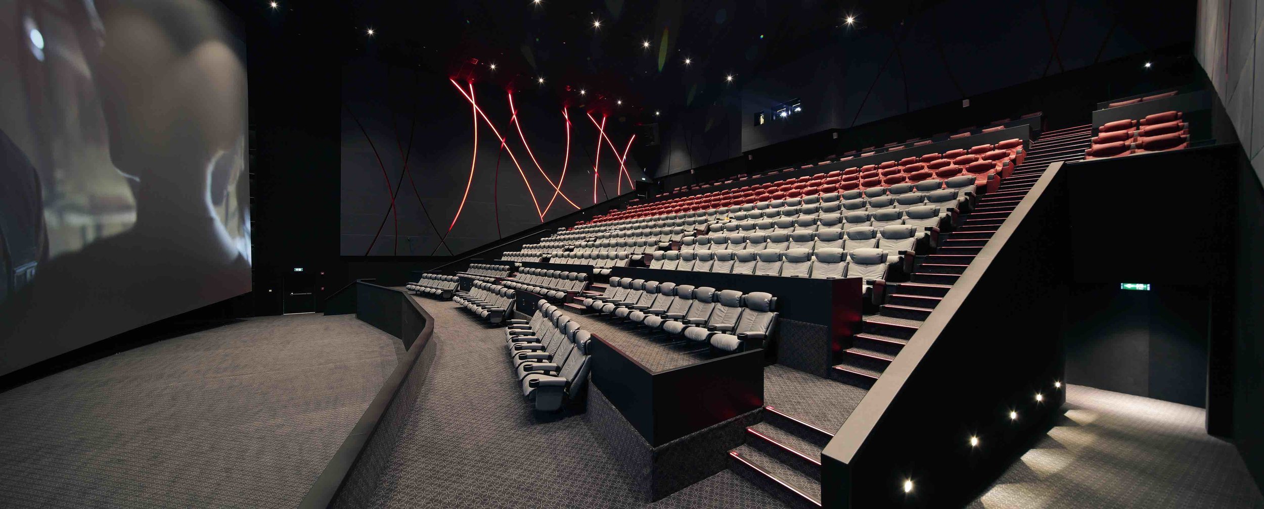 cinema auditorium with lots of black cinema chairs