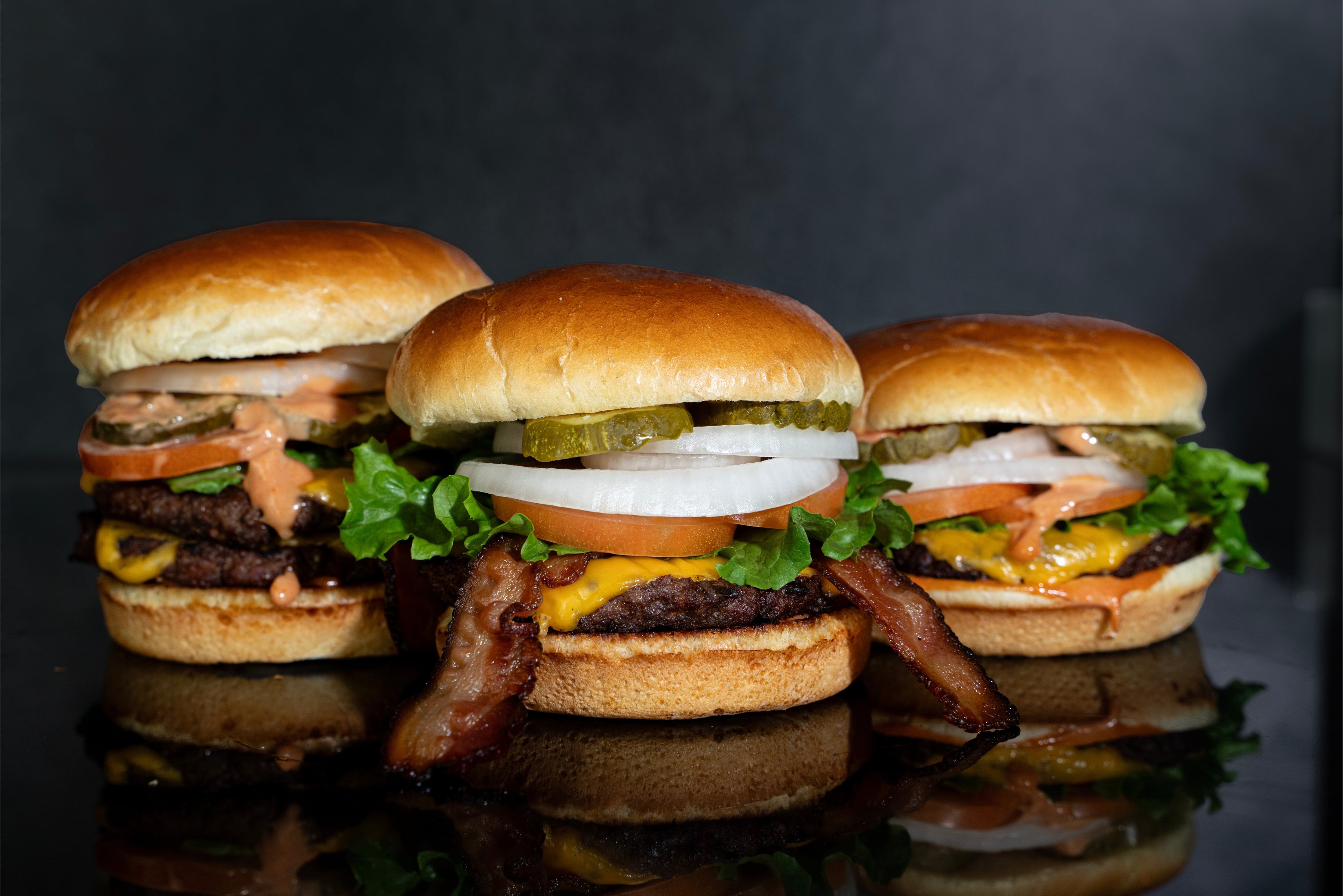 3 burgers: LtR - Double cheeseburger, bacon cheeseburger, signature cheeseburger