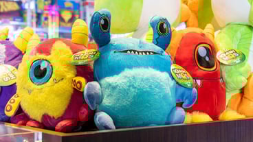various colorful stuffed alien creatures - prizes from the redemption store.