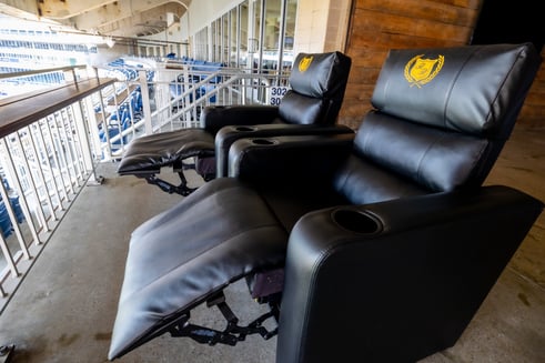 side profile of two black reclining seats in the reclined position at Kauffman stadium