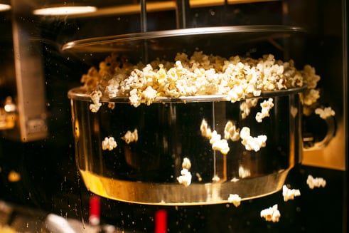 popcorn popping out of kettle