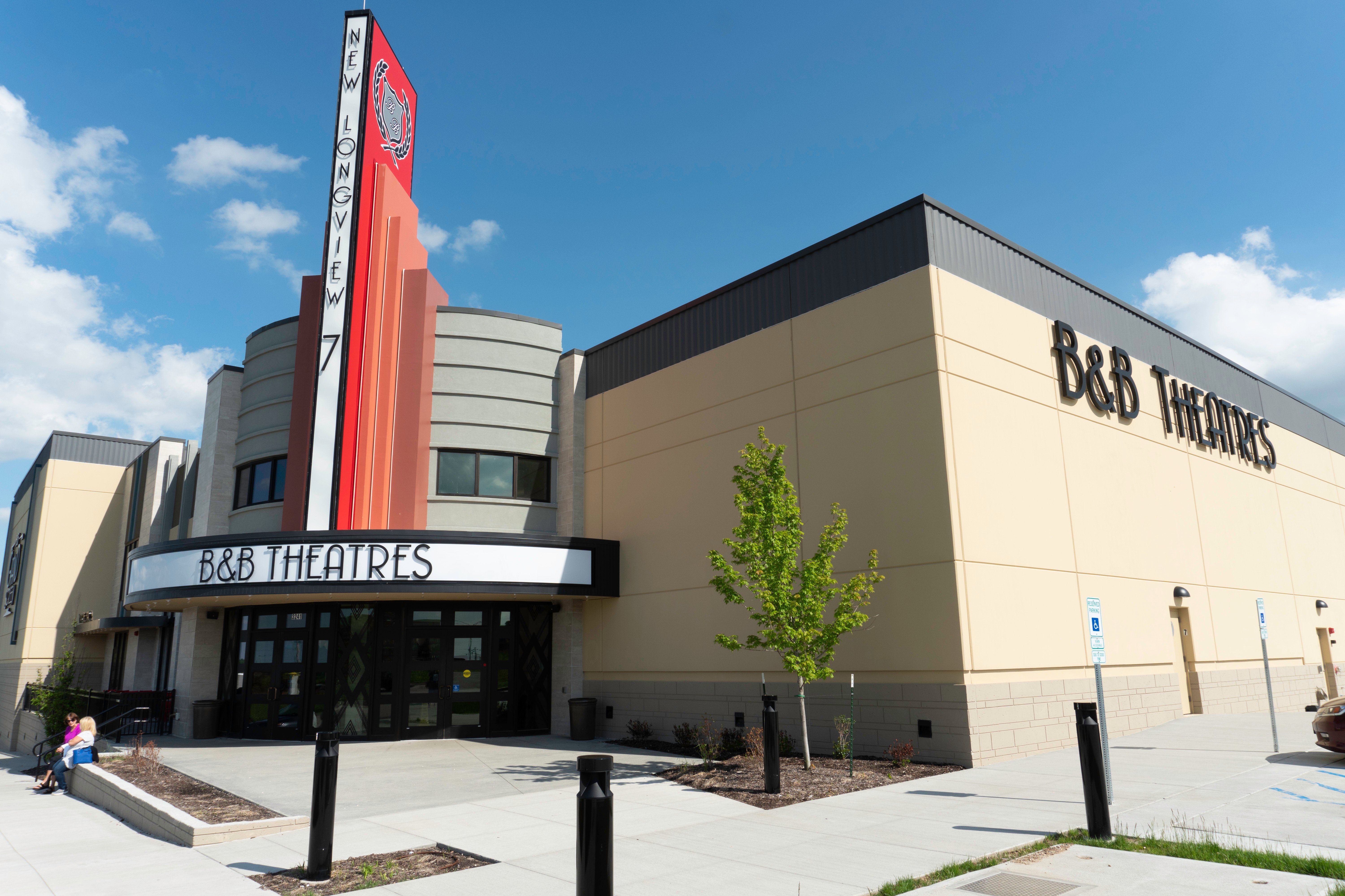 exterior of building showing 2 signs. One says NEW LONGVIEW 7 B&B Theatres. The other is on the side of the building & reads B&B Theatres