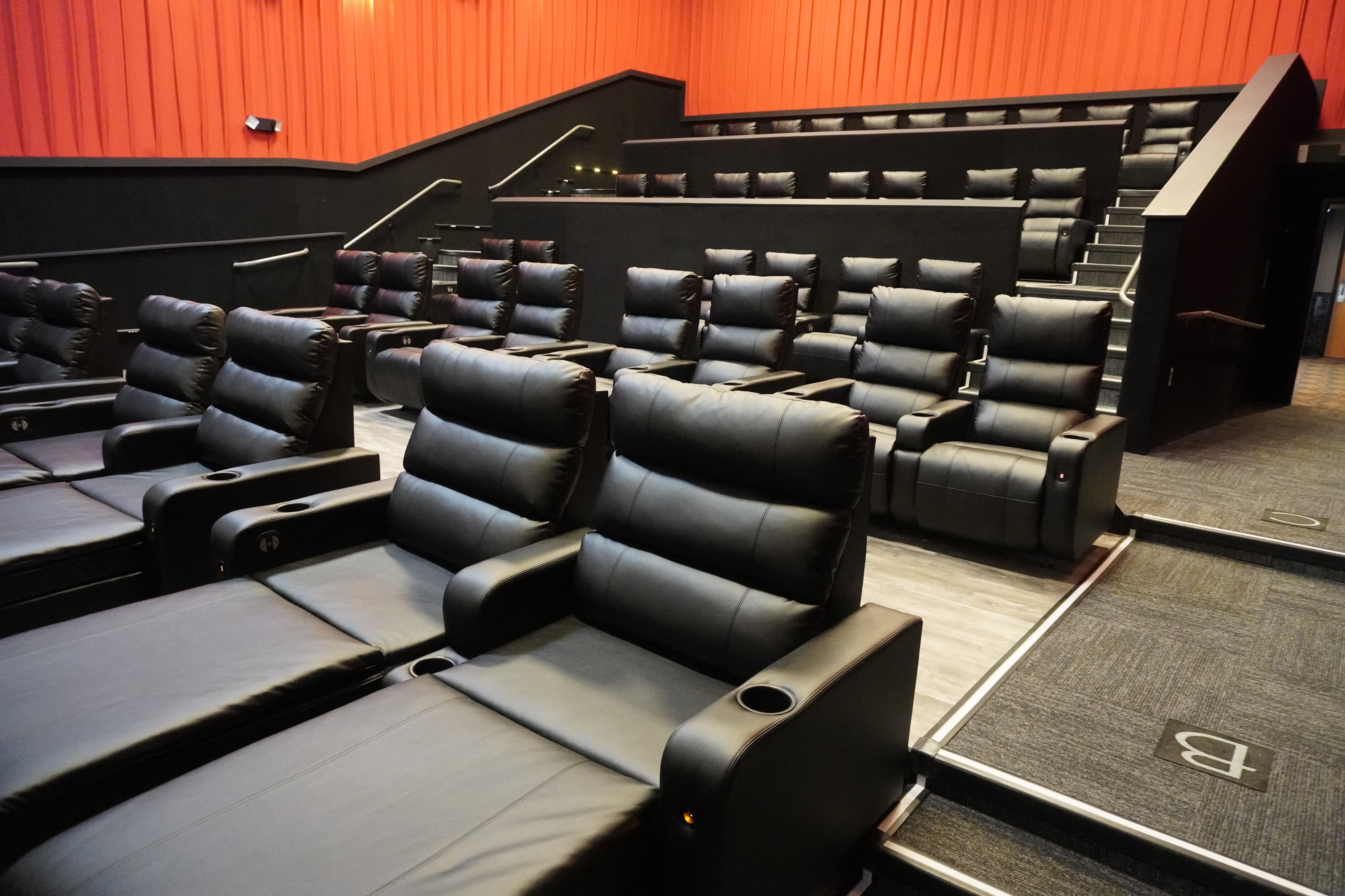 room of black recliner seats. 